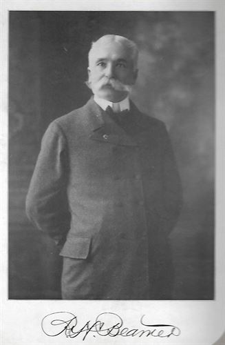 portrait of older man in a suit with a white mustache. Picture is in black and white and says in cursive Beamer